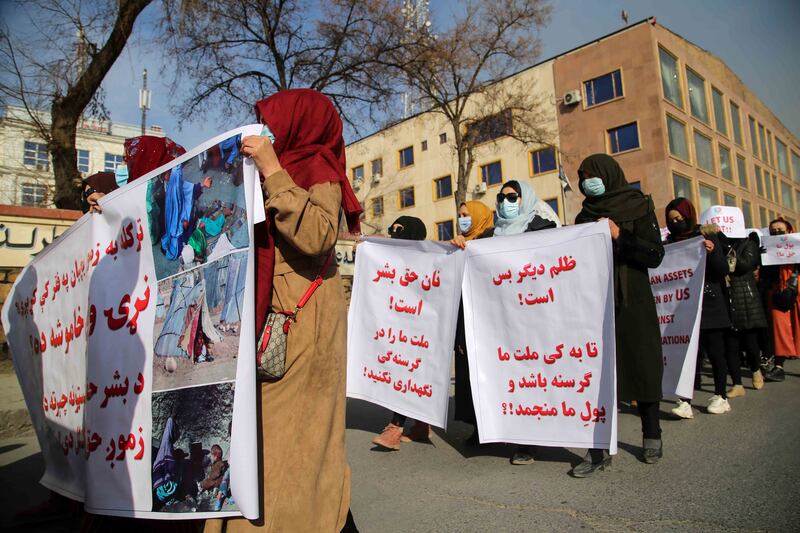 Women carry placards during a rally in Kabul.