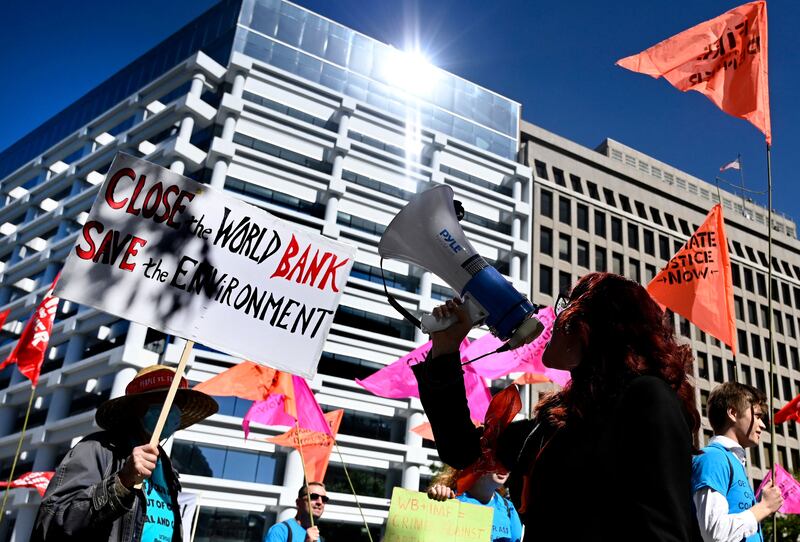 Climate activists outside the World Bank headquarters protest against fossil fuel projects during the IMF and World Bank annual meetings in Washington, DC. AFP
