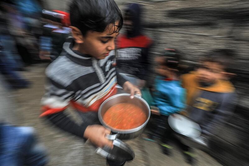 A boy leaves with hot food. EPA