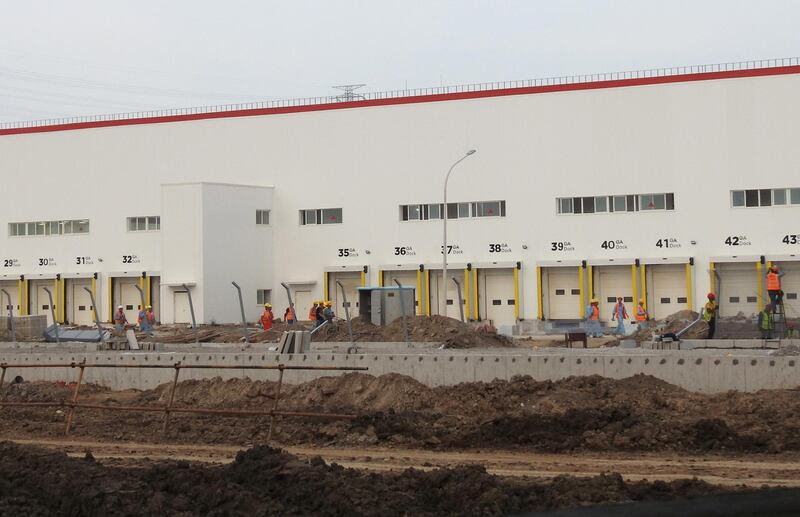 Workers are seen at the construction site of U.S. electric carmaker Tesla's Gigafactory in Shanghai, China September 28, 2019. Picture taken September 28, 2019.  REUTERS/Yilei Sun