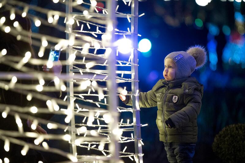 A boy poses for his mother at the Christmas fair near the Arch of the Triumph in Chisinau, Moldova.  EPA