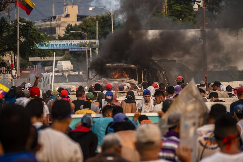 A truck is lit on fire during clashes on the Simon Bolivar International Bridge. Bloomberg