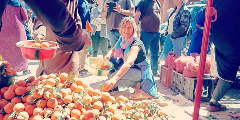 Mohammed El Arkam, Morocco: A lady is seen happily picking out oranges in the local souq of Ijjoukak in Morocco.