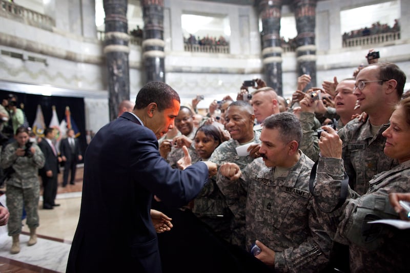 Mr Obama receives a fist-bump from a US soldier as he greets hundreds of US troops during his visit to Camp Victory, Iraq, April 7, 2009. Photo courtesy of the National Archives