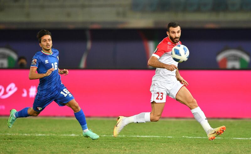 Mubarak Al Faneeni, left, of Kuwait and Jordan's Ehsan Haddad chase a loose ball during a Group B World Cup qualifier at Jaber Al Ahmad International Stadium in Kuwait City, Kuwait. It ended a nil-nil draw. EPA