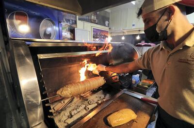 Dubai, United Arab Emirates - Reporter: Janice Rodrigues. Lifestyle. Food. Turkish Kokore & Sea Foods cook a kokorec. Food vendors from all over the world at Gobal Village. Dubai. Sunday, January 17th, 2021. Chris Whiteoak / The National