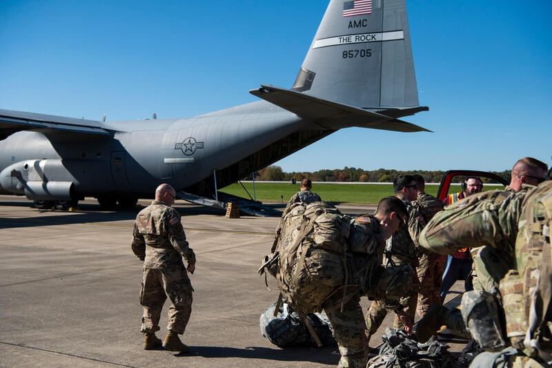 This Oct. 29, 2018 photo provided by the U.S. Air Force shows deployers from Headquarters Company, 89th Military Police Brigade, Task Force Griffin get ready to board a C-130J Super Hercules from Little Rock, Arkansas, at Fort Knox, Kentucky, in support of Operation Faithful Patriot. The Trump administration on Monday, Oct. 29, 2018, announced plans to deploy 5,200 active duty troops, double the 2,000 who are in Syria fighting the Islamic State group, to the border to help stave off the caravans. The main caravan, still in southern Mexico, was continuing to melt away, from the original 7,000 to about 4,000, as a smaller group apparently hoped to join it. (Airman 1st Class Zoe M. Wockenfuss/U.S. Air Force via AP)