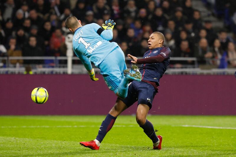 Lyon's goalkeeper Anthony Lopes, left, collides with PSG's Kylian Mbappe Lottin, right, as they challenge for the ball during the French League One soccer match between Lyon and Paris Saint Germain in Decines, near Lyon, central France, Sunday, Jan. 21, 2018. (AP Photo/Laurent Cipriani)