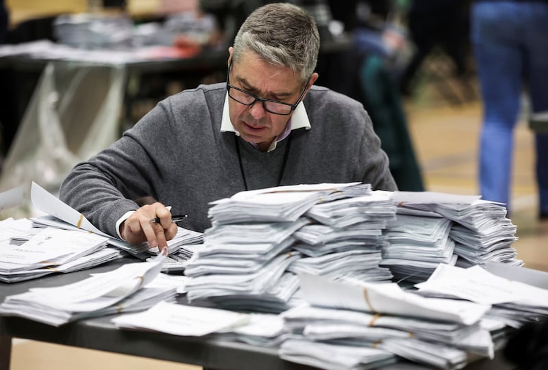 An election official counts votes. Reuters