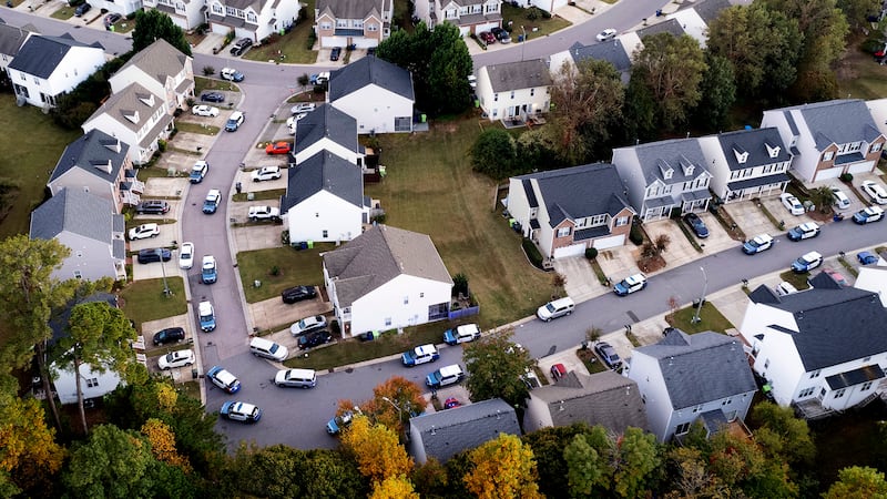 In this aerial image taken with a drone, police officers work at the scene of a shooting in a Raleigh district. AP