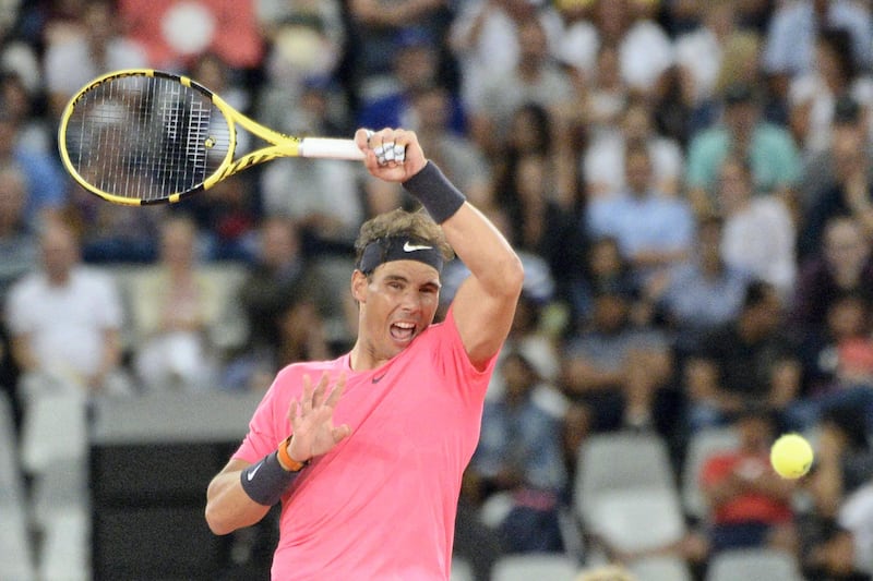 Spain's Rafael Nadal plays a return to Switzerland's Roger Federer during their tennis match at The Match in Africa at the Cape Town Stadium, in Cape Town on February 7, 2020. (Photo by RODGER BOSCH / AFP)