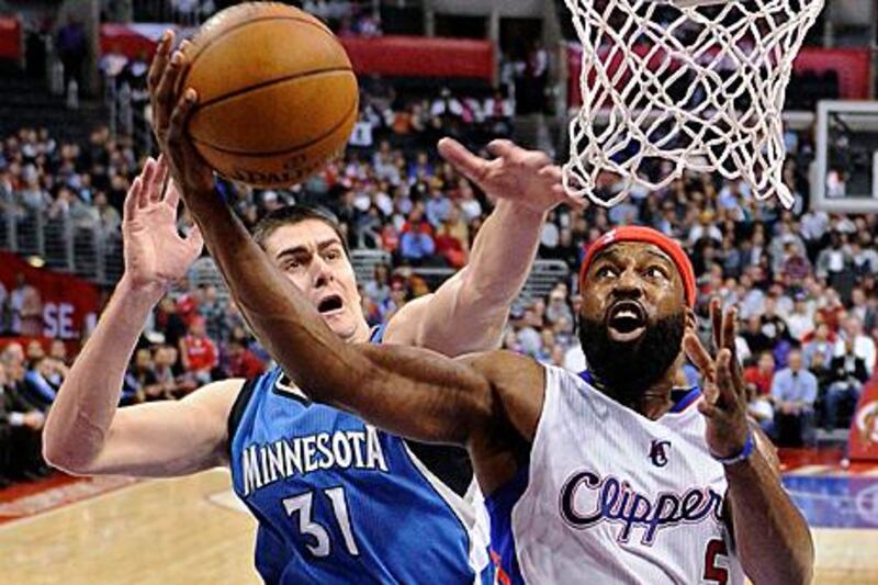 Los Angeles Clippers guard Baron Davis, right, puts up a shot as the Minnesota Timberwolves centre Darko Milicic defends during the Clippers' win in LA.