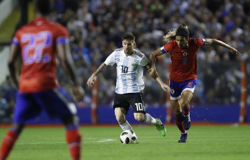 Argentina's Lionel Messi vies for a ball against Haiti's Zachary Herivaux. David Fernandez / AP Photo