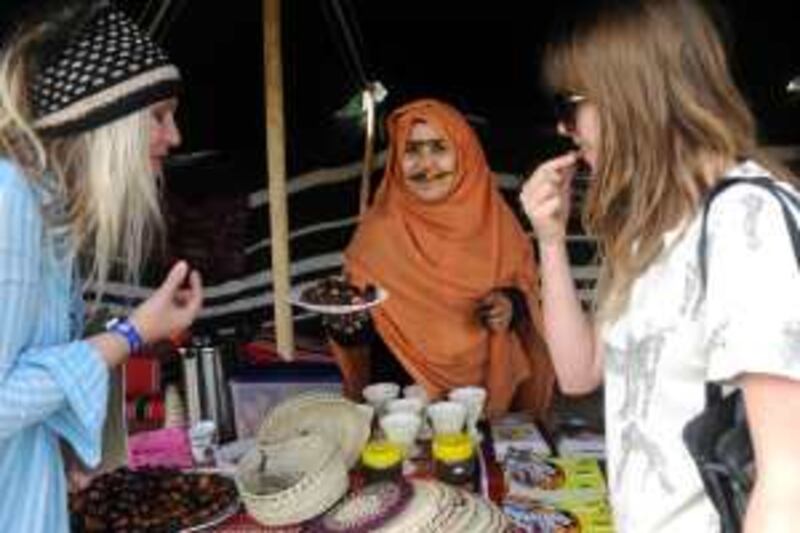 Festival-goers are served dates at the ADACH sponsored UAE tent on the first day of the WOMAD festival, UK, July 24, 2009. Zak Hussein for The National