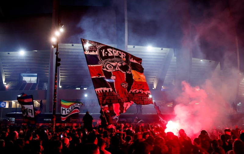 Fans celebrate with flares outside the stadium. Reuters