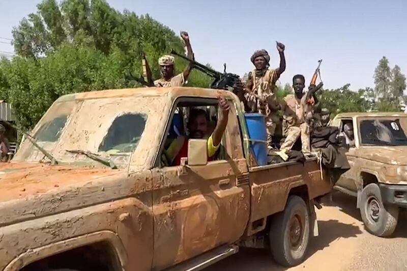 Members of the Rapid Support Forces travel through greater Khartoum. The group has been fighting against the army since April. AFP