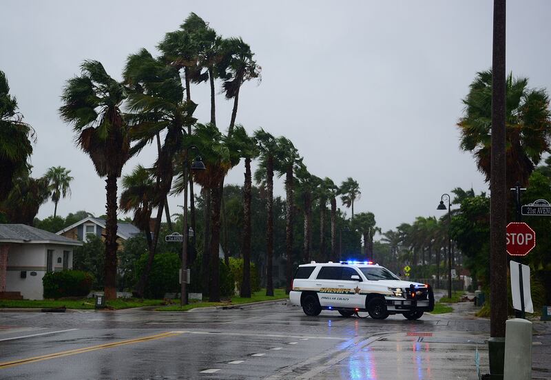 A police patrol drives around a neighbourhood of St  Petersburg Beach as the wind from Hurricane Ian arrives in Florida.  AFP