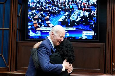 President Joe Biden hugs Supreme Court nominee Judge Ketanji Brown Jackson as they watch the Senate vote on her confirmation from the Roosevelt Room of the White House in Washington on Thursday, April 7, 2022.  AP