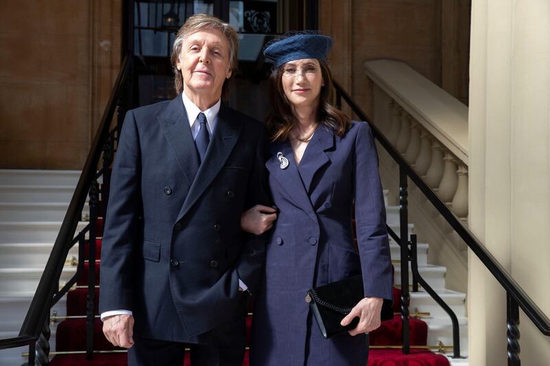 British musician Paul McCartney and his wife Nancy Shevell arrive for an investiture ceremony at Buckingham Palace in London where he will be made a Companion of Honour on May 4, 2018. (Photo by Steve Parsons / POOL / AFP)