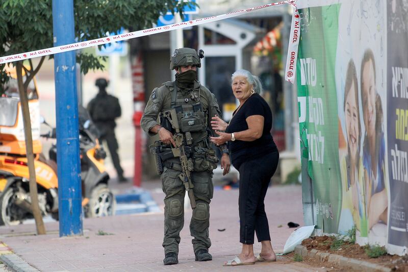 Israeli soldiers take position near a police station that was overrun by Hamas militants on Saturday in Sderot. AP