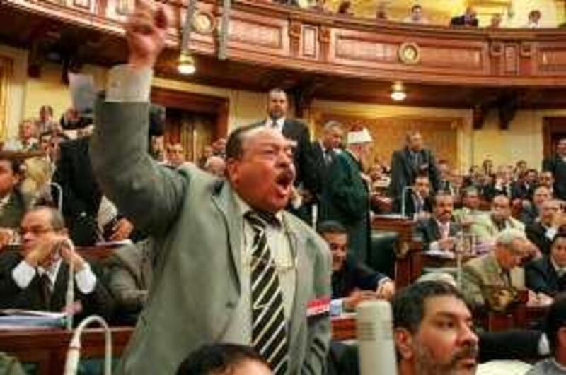 An unidentified Egyptian Muslim Brotherhood MP reacts during a parliamentary session held in Cairo on May 26, 2008 to extended a controversial decades-old state of emergency by two years. The extension was approved despite pledges to replace it by new legislation, in a move slammed by rights groups as anti-constitutional. "Parliament has accepted during its afternoon session today the decision by the president of the republic to extend the state of emergency for two years starting from June 1, or until a new terror law is drafted, whichever comes first," the state news agency MENA said. The state of emergency was first imposed in 1981 after the assassination by Islamists of president Anwar Sadat and has been repeatedly renewed since then despite protests from rights groups and regime opponents. AFP PHOTO/STR