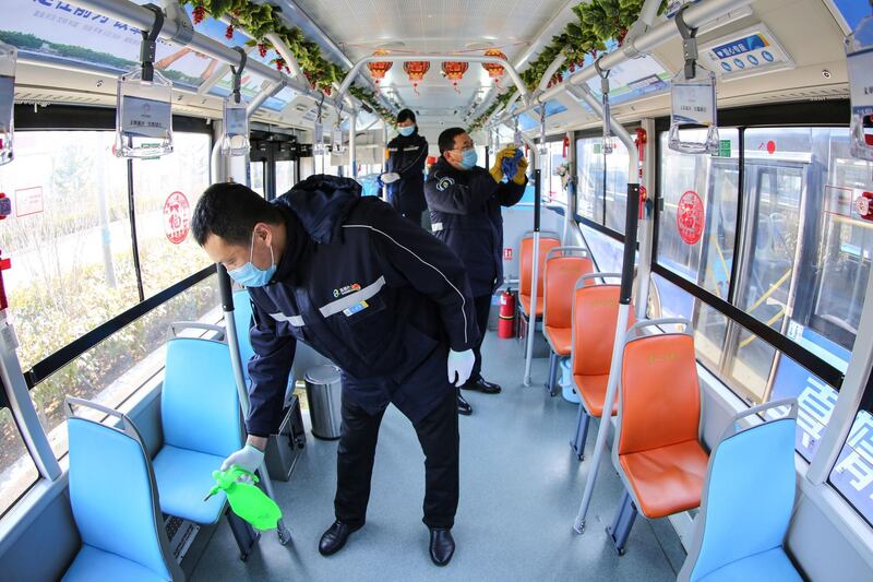 Staff members disinfecting a bus in Qingdao, in China's eastern Shandong province, amid a virus outbreak that originated from Hubei's provincial capital city of Wuhan. AFP