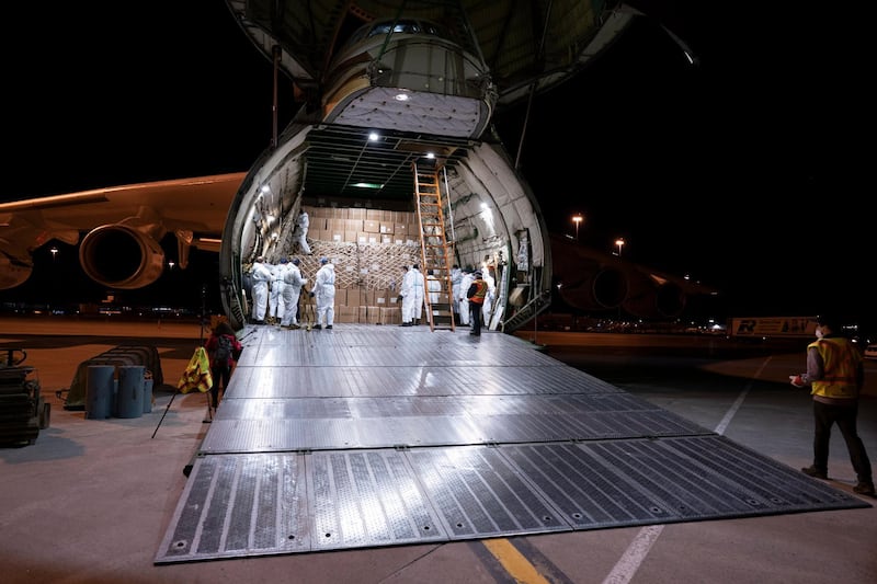 A crew gets ready to unload medical supplies from an Antonov AN-225 cargo transporter upon arriving from China at Mirabel Airport in Mirabel, Quebec. The Canadian Press via AP