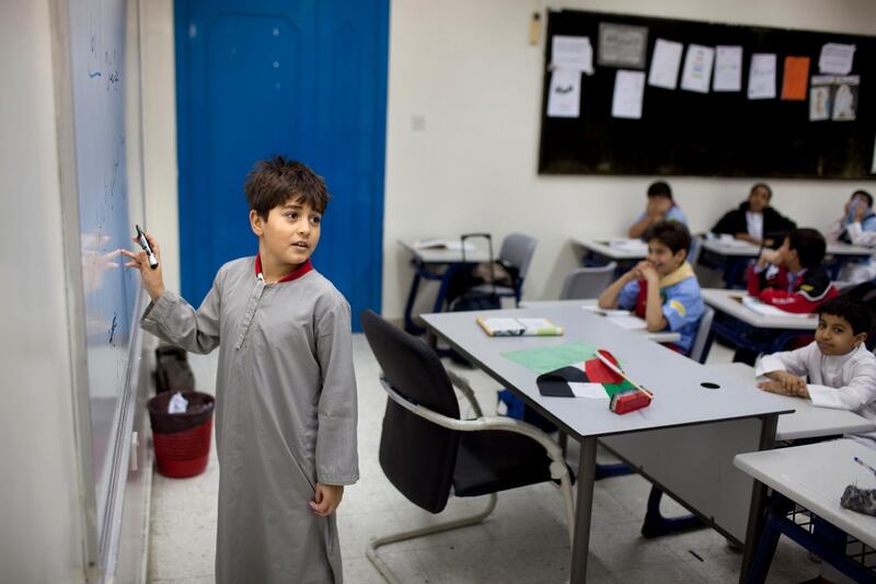 Al Ruwais Primary Boys School students work on reading problems during an Arabic language class on Thursday, Nov. 24, 2011 at the school's campus in Ruwais. (Silvia Razgova/The National)
