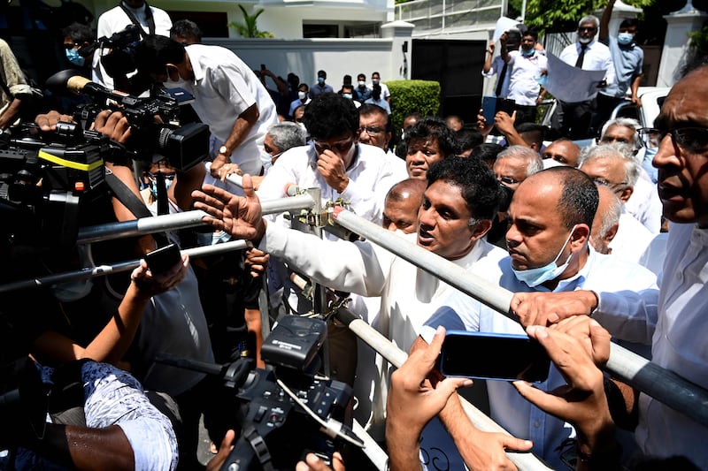 Sri Lanka's main opposition leader Sajith Premadasa (C) and MPs members shout during a protest in Colombo. AFP