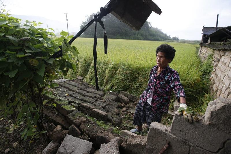 A South Korean earthquake victim stands by her damaged house following a 5.8 magnitude earthquake on September 12, in Gyeongju-city, Gyeongsangbuk-do. EPA