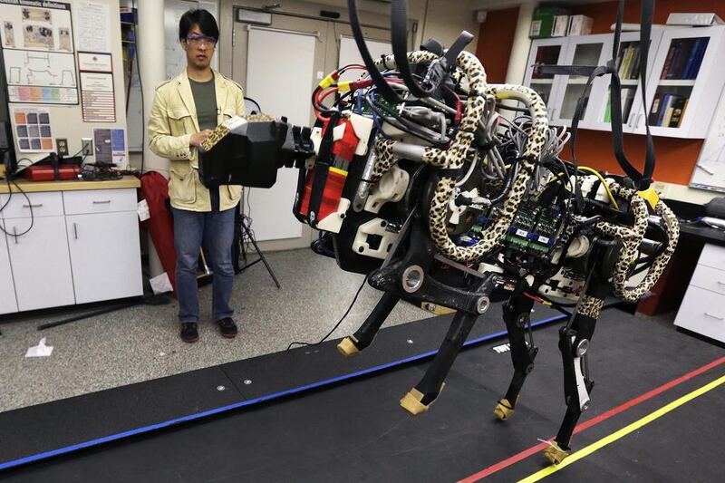 A professor at MIT controls a robotic cheetah. Charles Krupa / AP Photo