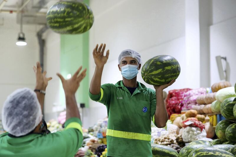 Dubai, United Arab Emirates - N/A. News. Coronavirus/Covid-19. Two men load up watermelons at the Waterfront Market in Deira. Thursday, September 10th, 2020. Dubai. Chris Whiteoak / The National