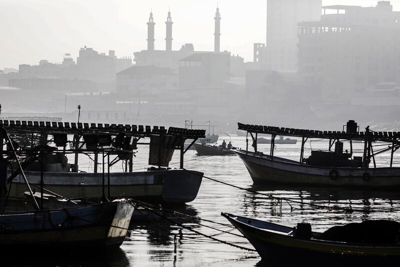 Boats of Palestinian fishermen sail through Gaza port in Gaza City.   EPA