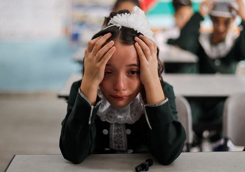 A classmate of Palestinian student Lian Al Shaer, 10, who was killed in recent Israel-Gaza fighting, is in grief as the new school year begins in Khan Younis, the Gaza Strip. Reuters