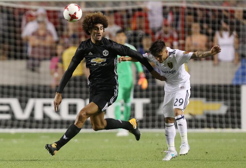 Manchester United midfielder Marouane Fellaini, left, in action. Jim Urquhart / Reuters