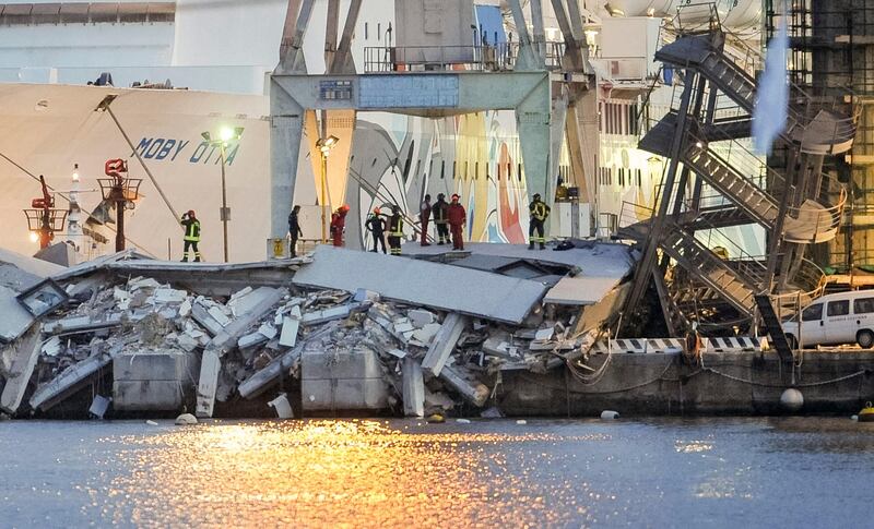 Rescuers search what is left of the control tower of the port of Genoa, northern Italy, after it collapsed when a cargo ship slammed into it killing at least three people, Tuesday, May 7, 2013. A half-dozen people remain unaccounted for early Wednesday, after a cargo ship identified as the Jolly Nero of the Ignazio Messina & C. SpA Italian shipping line, slammed into the port. (AP Photo/Francesco Pecoraro) *** Local Caption ***  Italy Cargo Ship Crash.JPEG-045cc.jpg
