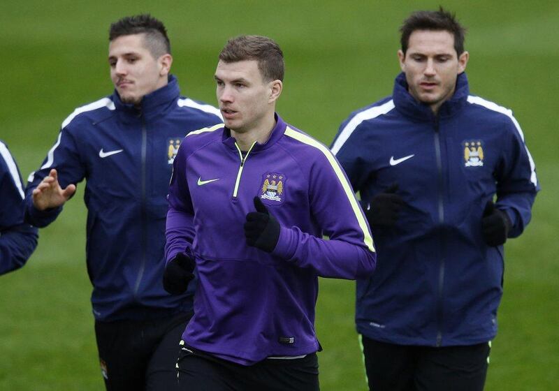 Edin Dzeko trains with Manchester City on Tuesday ahead of their Wednesday match against AS Roma in the Champions League. Phil Noble / Reuters / December 9, 2014