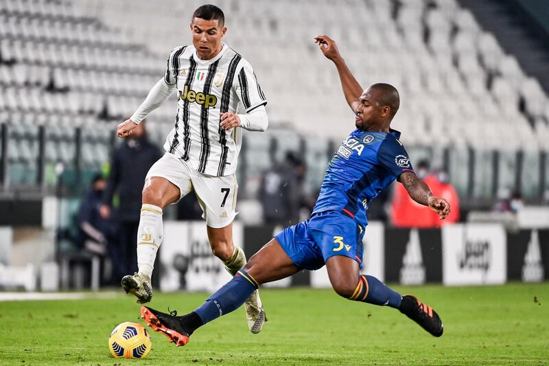 Juve's Cristiano Ronaldo is challenged by Samir Santos of Udinese. AP