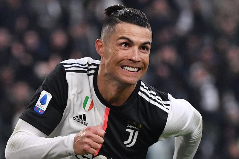 (FILES) In this file photo taken on January 06, 2020 Juventus' Portuguese forward Cristiano Ronaldo celebrates after scoring his third goal during the Italian Serie A football match Juventus vs Cagliari at the Juventus Allianz stadium in Turin. Italy's top-flight Serie A clubs said on May 13, 2020 they want to return to competition on June 13 if they get the all-clear from the government. / AFP / Marco Bertorello
