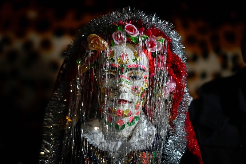 Bulgarian Pomak (Bulgarian speaking Muslims) bride Nefie Eminkova, 21, poses during her wedding ceremony in the village of Ribnovo, on January 9, 2022.  - Dark blonde Nefie Eminkova, 21, and her fiancee Schaban Kiselov, 24, are tying the knot in a flurry of bright colours, flowers, dancing and blessings.   (Photo by Nikolay DOYCHINOV  /  AFP)