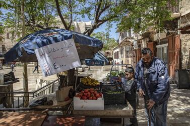 A vendor arranges fresh produce on display for sale at a souk in Sidon, Lebanon. Bloomberg