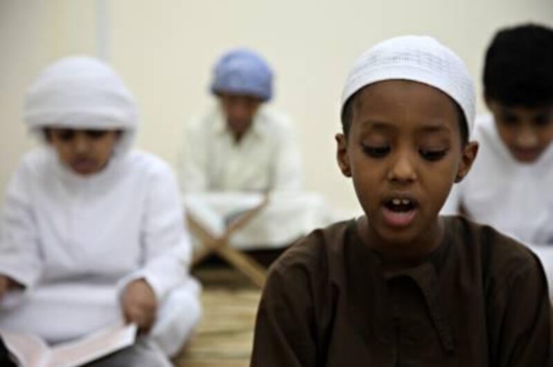 August 16 2011- Shahama, UAE - August 16 2011 - Shahama, UAE - Saber Saeed (7) is originally from Somalia but lives in Al-Bahia. He memorizes the Koran during afternoon class at the Islamic Centre for Memorization of the Koran in Old Shahama. "I want to learn the Koran because it is the word of God", Saber states confidently. (Razan Alzayani / The National) 