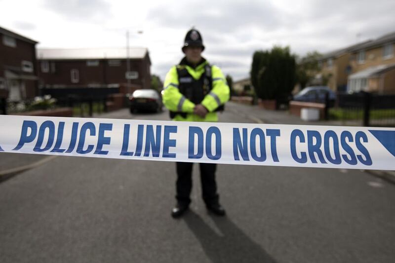 A police officer guards the entrance to a street in the Moss Side area of Manchester on May 28, 2017 as part of the investigation into the suicide bombing of a pop concert that killed 22 people. / AFP / JOHN SUPER

