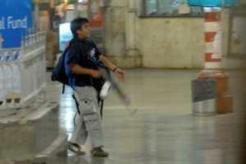 A gunman walks at the Chatrapathi Sivaji Terminal railway station in Mumbai, India, Wednesday, Nov. 26, 2008. Teams of gunmen stormed luxury hotels, a popular restaurant, hospitals and a crowded train station in coordinated attacks across India's financial capital, killing people, taking Westerners hostage and leaving parts of the city under siege Thursday, police said. A group of suspected Muslim militants claimed responsibility. (AP Photo/Mumbai Mirror, Sebastian D'souza) ** INDIA OUT CREDIT MANDATORY ** *** Local Caption ***  SAB801_India_Shooting.jpg *** Local Caption ***  SAB801_India_Shooting.jpg