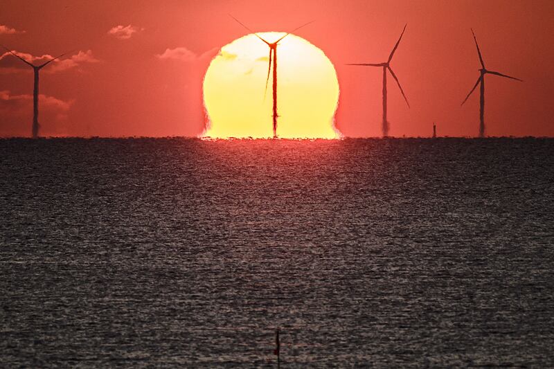 The sun sets over an offshore wind farm, off the coast of the French Western city of Saint-Nazaire. AFP
