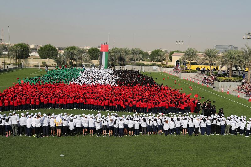 Abu Dhabi, United Arab Emirates - November 28th, 2017: GEMS Education students attempt to set a world record for the Worlds Largest Human Waving Flag. Tuesday, November 28th, 2017 at GEMS Cambridge International School, Abu Dhabi. Chris Whiteoak / The National