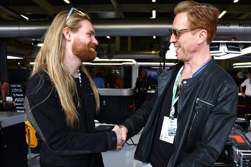 Damien Lewis and Sam Ryder meet outside the Red Bull garage. Getty