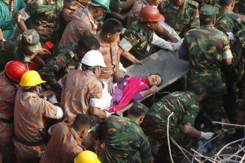 Rescuers carry Reshma, a garment-factory worker, from the rubble on May 10, 17 days after the eight-storey building in which she worked collapsed. AFP