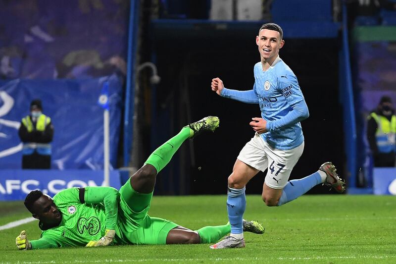 LONDON, ENGLAND - JANUARY 03: Phil Foden of Manchester City celebrates after scoring their sides second goal as Edouard Mendy of Chelsea looks dejected during the Premier League match between Chelsea and Manchester City at Stamford Bridge on January 03, 2021 in London, England. The match will be played without fans, behind closed doors as a Covid-19 precaution. (Photo by Andy Rain - Pool/Getty Images)