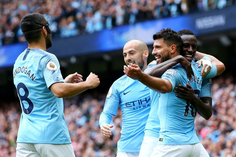Aguero celebrates with teammates after scoring his team's third goal. Getty Images